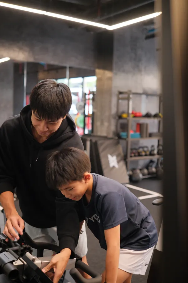 PGP coach guiding a young athlete through a bike test