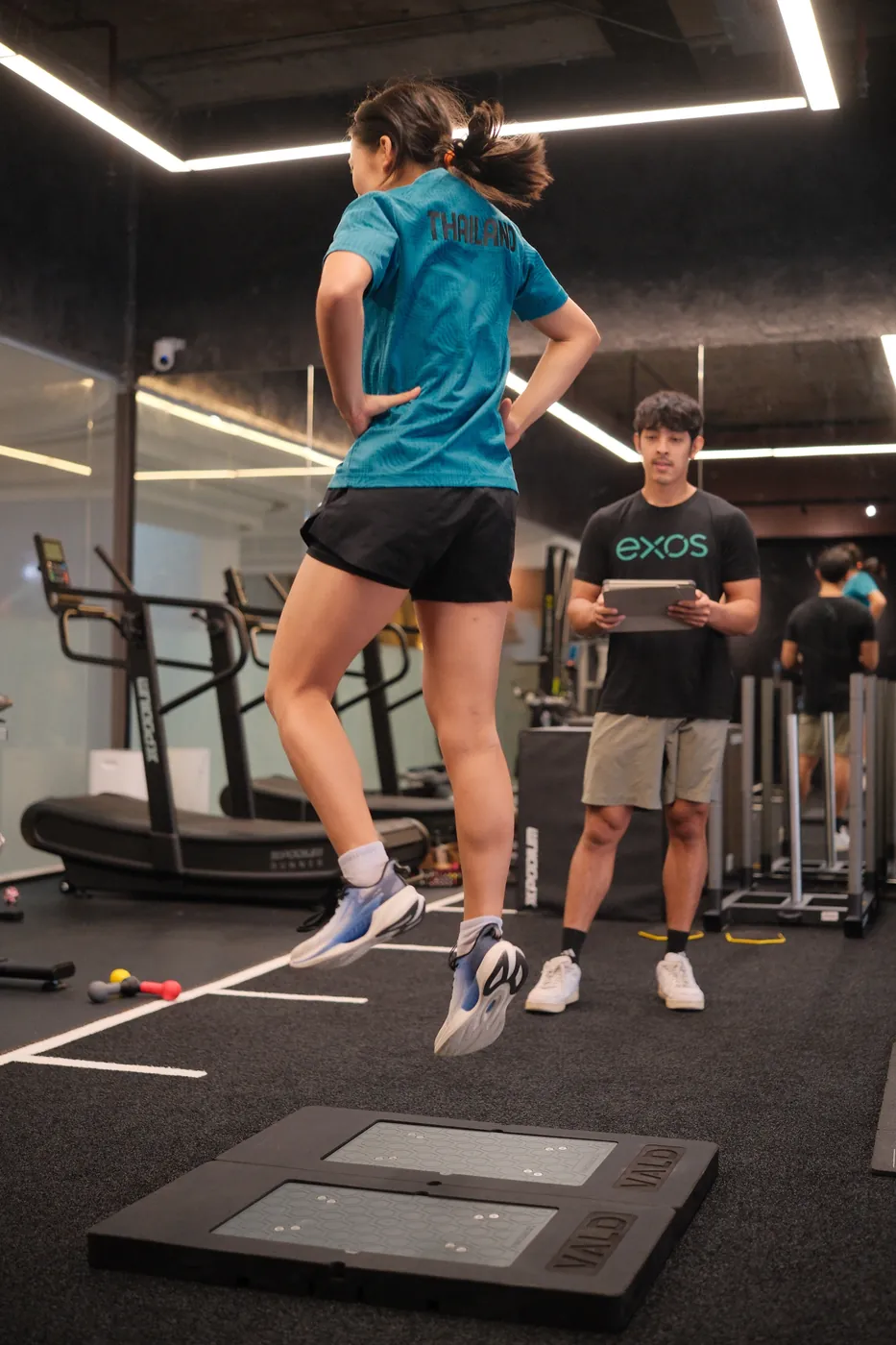 Athlete mid-air during a countermovement jump test on VALD ForceDecks force plates at the PGP Studio